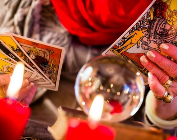 Female Fortuneteller or esoteric Oracle, sees in the future by playing her tarot cards during a Seance to interpret them and to answer questions